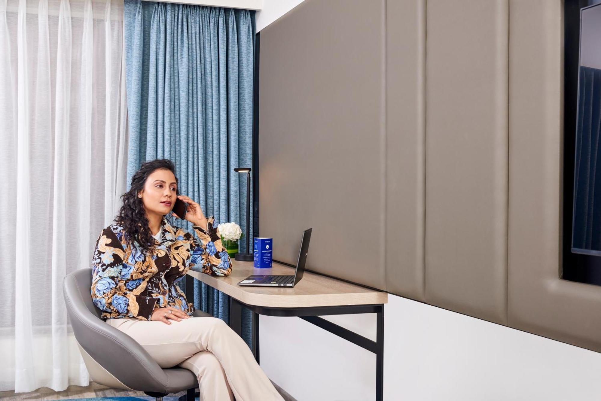 Novotel Mumbai International Airport 외부 사진 A woman working from home